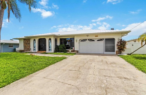 Port Charlotte House | Experience serenity in this fully furnished 3-bed, 3-bath waterfront home featuring a heated pool, spacious layout, and abundant natural light. Enjoy stunning water views from the master suite, living room and Florida room.