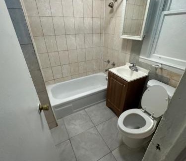 Irvington House | Fidelia Emerald Room Queen Bed within minutes of Newark Liberty International Airport and Newark Penn Station