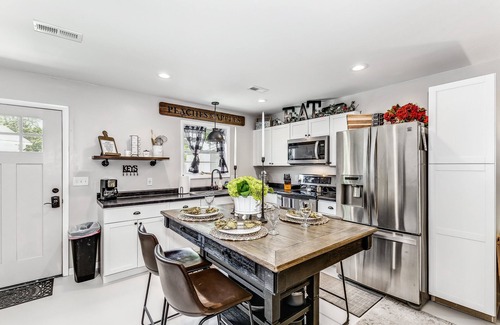 Wichita House | Front door parking, private covered patio with fenced in backyard