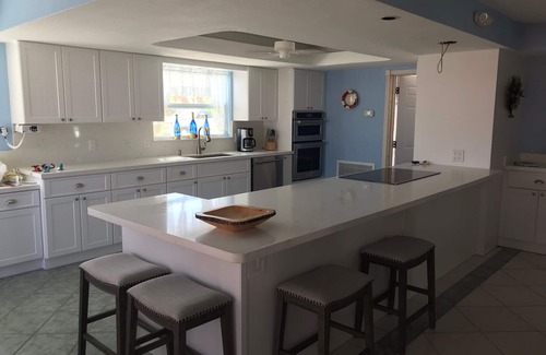 Farara Shores House | Ground level house with pool and canal to ocean