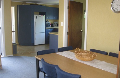 Waitarere Beach House | HAPPY HAVEN has Kiwi Bach character with location.