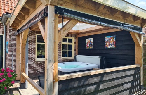 Oudeslius House | Have a unique experience in the Boerderijkamer with private outdoor hot tub , breathtaking views and comfortable amenities. Enjoy a carefree stay with fresh rolls and delicious coffee every day and explore the surrounding area, the beach, Callantsoog