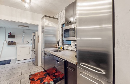 Poinciana Park House | Historic home in great locale with shared sauna, Ping-Pong, mini-golf, & grill