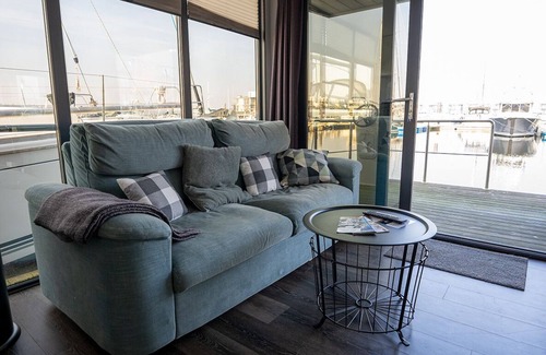 Flensburg Boat Rental | Houseboat Luv in Sonwik harbor with a view of Denmark