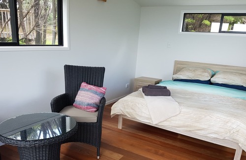 Kawau Island House | Kitchen and entertainment area with views and 3 pods for sleeping all separate