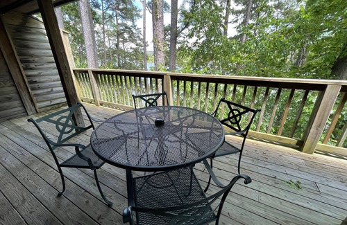 Mount Ida Cottage | Lake view two bedroom, two bath log-sided cottage with private hot tub overlooking Lake Ouachita. by RedAwning