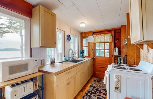 Laconia House | Lakefront cabin with deck, gas grill, kayaks, fireplace, & quick beach access