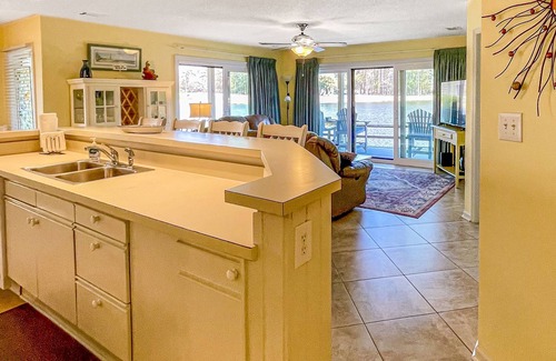 Sea Trail Condo | Lakefront condo with patio, AC, & water views plus pool & tennis