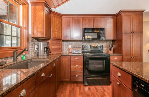 Conover House | Lakefront dog-friendly home with firepit, play set, dock, & beach access