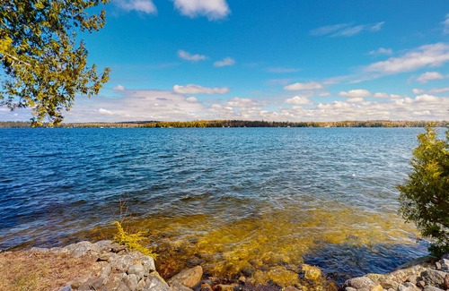 Otis House | Lakefront home with dock, kayak, firepit, screened porch, fireplace, & W/D