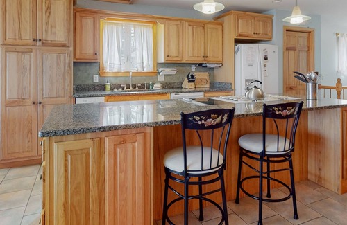 Otis House | Lakefront home with dock, kayak, firepit, screened porch, fireplace, & W/D