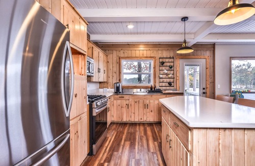 Sayner House | Lakefront home with private dock, deck, fireplace, firepit, canoe & paddleboat