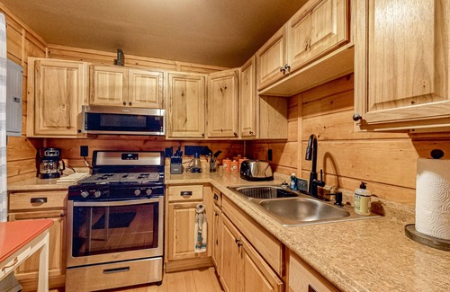 Three Lakes Cabin | Lakeside cabin with a firepit, sunroom, & seasonal dock