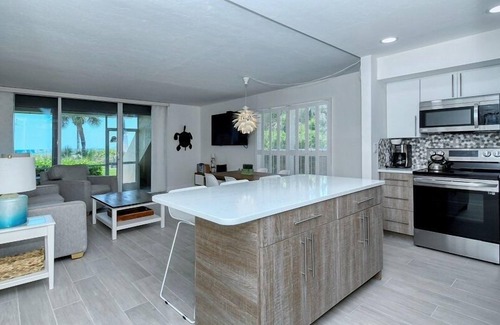Longboat Key Condo | LaPlaya 101A - Step out to the beach from your screened lanai. Light and bright end unit.