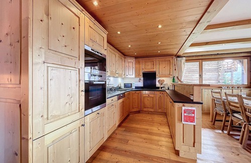 Verbier Apartment | Living room with Swedish fireplace, open kitchen with vitroceram, dishwasher, Nespresso machine and