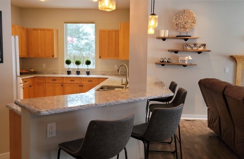 Bellaire Condo | LOCATION LOCATION! Golfers Paradise & ski in/out on the 18th green Cedar River