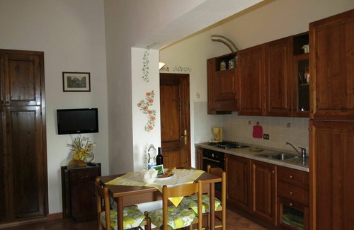 Lajatico Villa | Lovely apartment in villa for 2 guests with WIFI, pool, TV, patio and parking