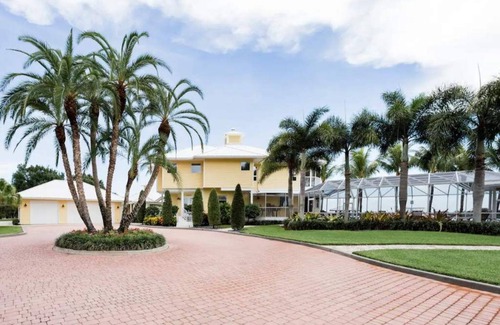Palm City House | Lush Waterfront Pool Home and Pool house with Pickleball court and Boat dock