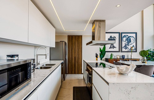 Flamingos Condo | Luxury ocean-view condo with resort pool, private balcony, and washer/dryer