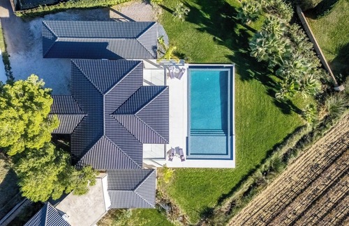 Plaissan Villa | Luxury SCL villa heated mirror pool exotic garden vineyard