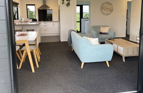 Raglan House | Modern, cozy, Beachy Bach with beautiful rural views in Raglan
