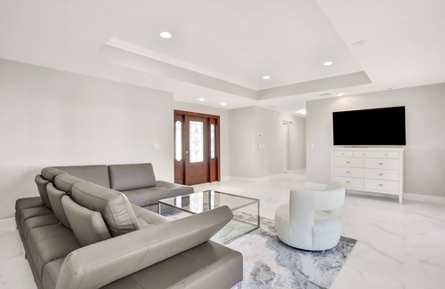 Palm River Estates House | Modern home with a pool, patio, hot tub, grill, washer/dryer, and central AC