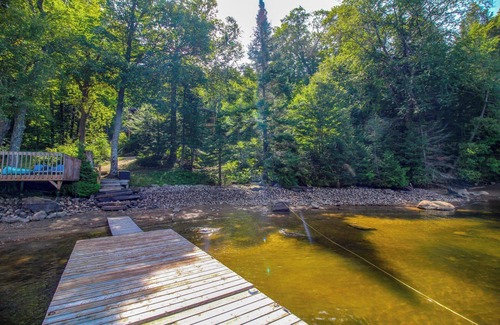 Dysart et al Cottage | Modern log cabin with wrap around deck on Little Kennisis