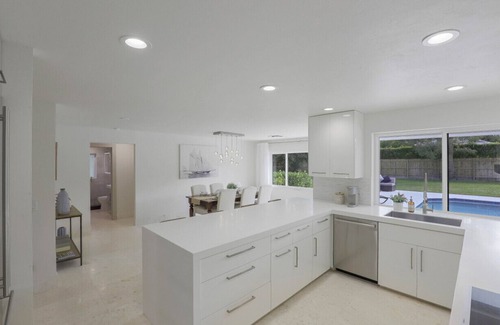 Moorings House | Modern Oasis: Private Beach Access. Minutes from Downtown & Optional Golf Cart