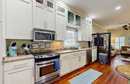 North-Central House | North Central, 30-Day Rental Home w/Double Porches, Garden Patio, and Free WiFi