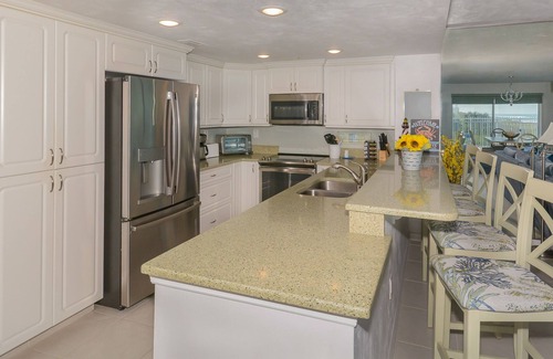Bethune Beach Condo | Ocean Condo 104 ~ Ground Floor Corner Condo with wrap around balcony! Walk right out to Pool!