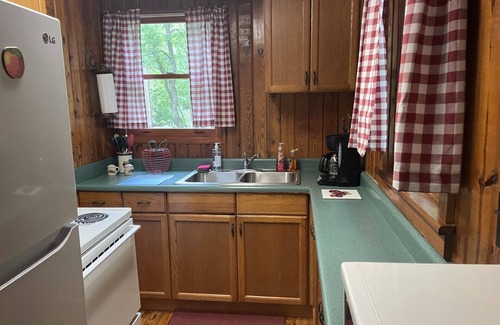 Bat Cave Cottage | On the River's Edge! Rocking chairs on large screened porch on river's edge.