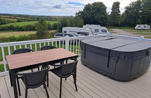 Grampound Resort | Our Kingfisher 34-4 persons with private hot tub-pet friendly-Tranquil holiday away from it all yet not far from St Austell- The Holiday Home has two bedrooms, living and dining area, equipped kitchen-Decking-outdoor furniture-Fishing lakes-Perfect