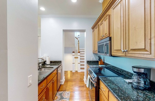 St. Marys House | Palm-lined home with dock access, firepit & inviting balconies