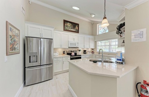 Holmes Beach Condo | Pink Flamingo in Palm Isle Village - 2BR Condo with Pool - By Island Real Estate
