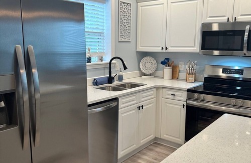 Southport Condo | POOL AND PICKLEBALL! Perfectly located 1st floor condo, close to everything