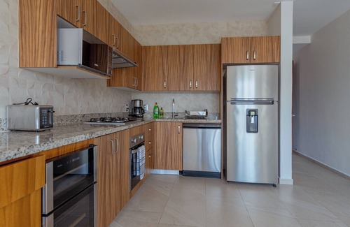 North Hotel Zone Condo | Porto Santo beautiful 1 bedroom flex, king bed+sofa bed steps from playa de oro.