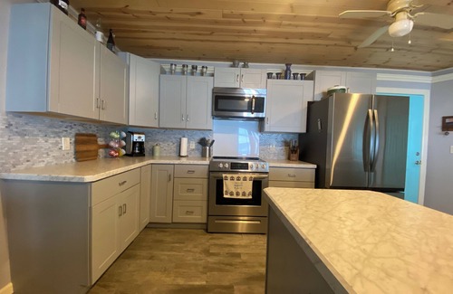 Little Sturgeon House | Prime sunsets, great kayaking, huge yard, volleyball court, and free firewood