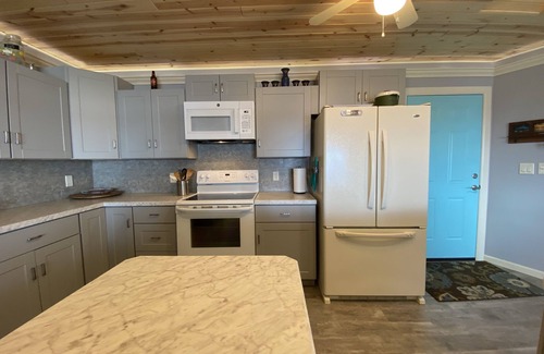 Little Sturgeon House | Prime sunsets, great kayaking, huge yard, volleyball court, and free firewood