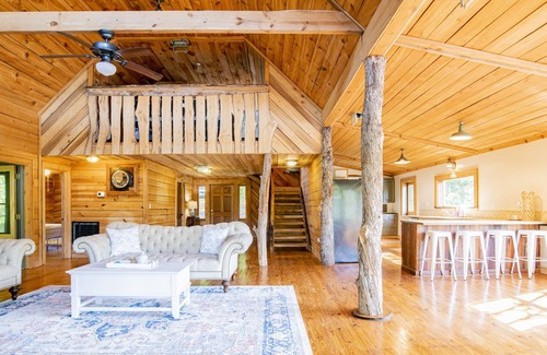 Fairhope Cabin | Private cabin built over a lake with a large breezy screened-in porch.