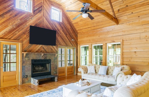 Fairhope Cabin | Private cabin built over a lake with a large breezy screened-in porch.