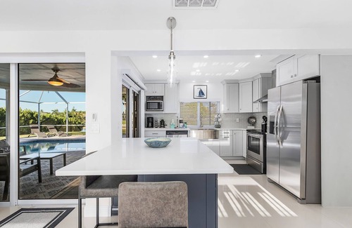 Caloosahatchee House | Private enclosed heated pool with Gulf access. Panoramic Lenai