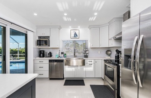 Caloosahatchee House | Private enclosed heated pool with Gulf access. Panoramic Lenai