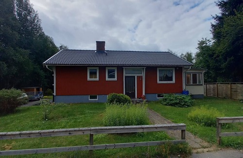 Korsberga Ski Chalet | Red and white vacation home in Småland near a lake with boat