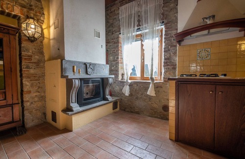 Castiglione della Pescaia Apartment | Reggia, in small medieval village characteristic apartment with fireplace