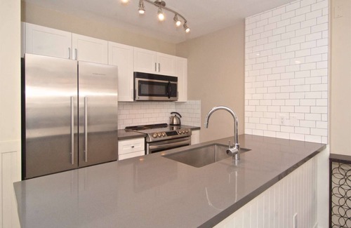 Village North Condo | Relax and Watch the activity of the Village on the oversized patio. Professionally Managed.