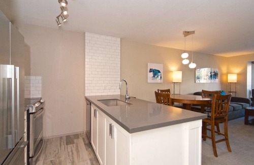 Village North Condo | Relax and Watch the activity of the Village on the oversized patio. Professionally Managed.