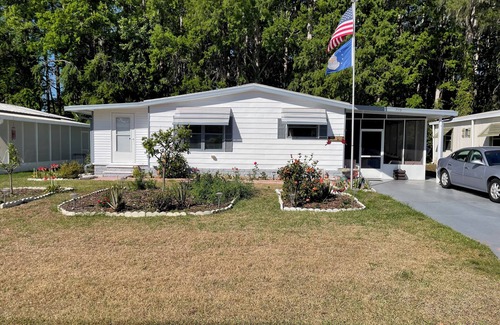 Wildwood House | Relax in style—lanai, golf cart & tranquil wooded views included!
