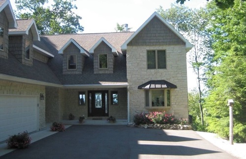 Egg Harbor House | Relax or do nothing at all high on the bluff with water views second to none.