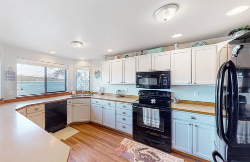 Belfair House | Relaxing bay front house with mountain views, lovely deck, wood-stove & firepit