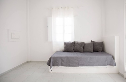 Perissa House | Relaxing environment under trees with a swimming pool, a pool bar.